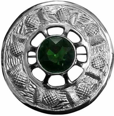 A plaid brooch featuring a thistle ring green stone silver finish